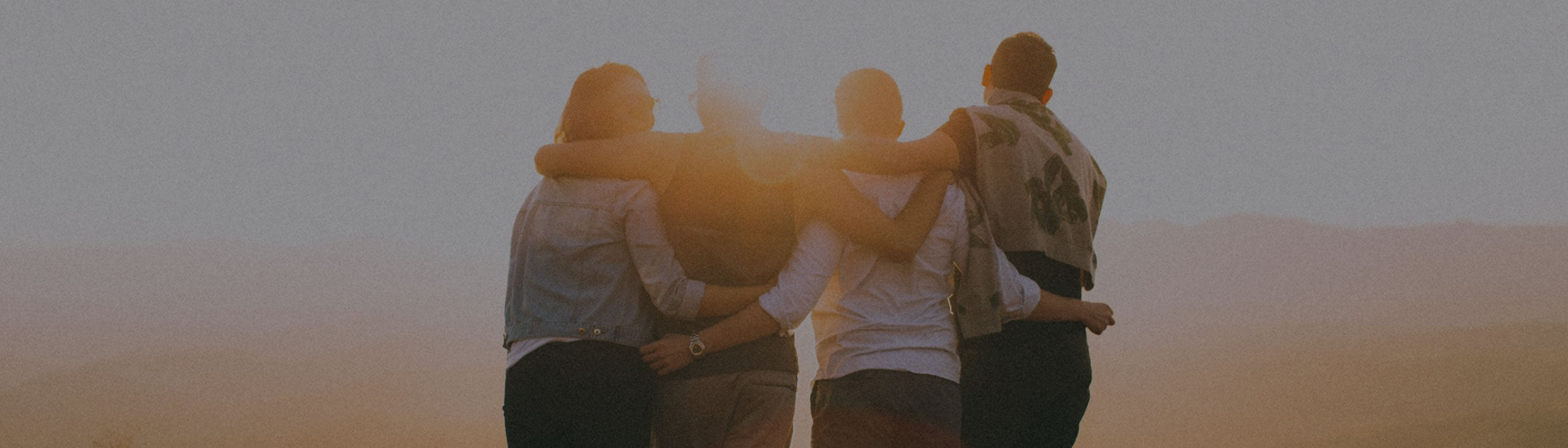 People hugging and standing together